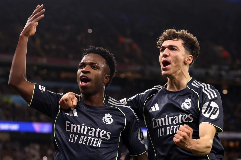 Real Madrid melaju ke perempat final Liga Champions usai mengalahkan Manchester City 2-1. Vinicius Junior jadi bintang, Courtois tampil impresif.